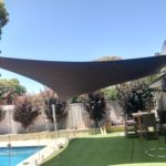Shade Sail over landscaped area beside swimming pool