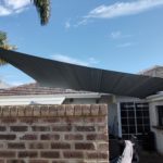 large shade sail over courtyard